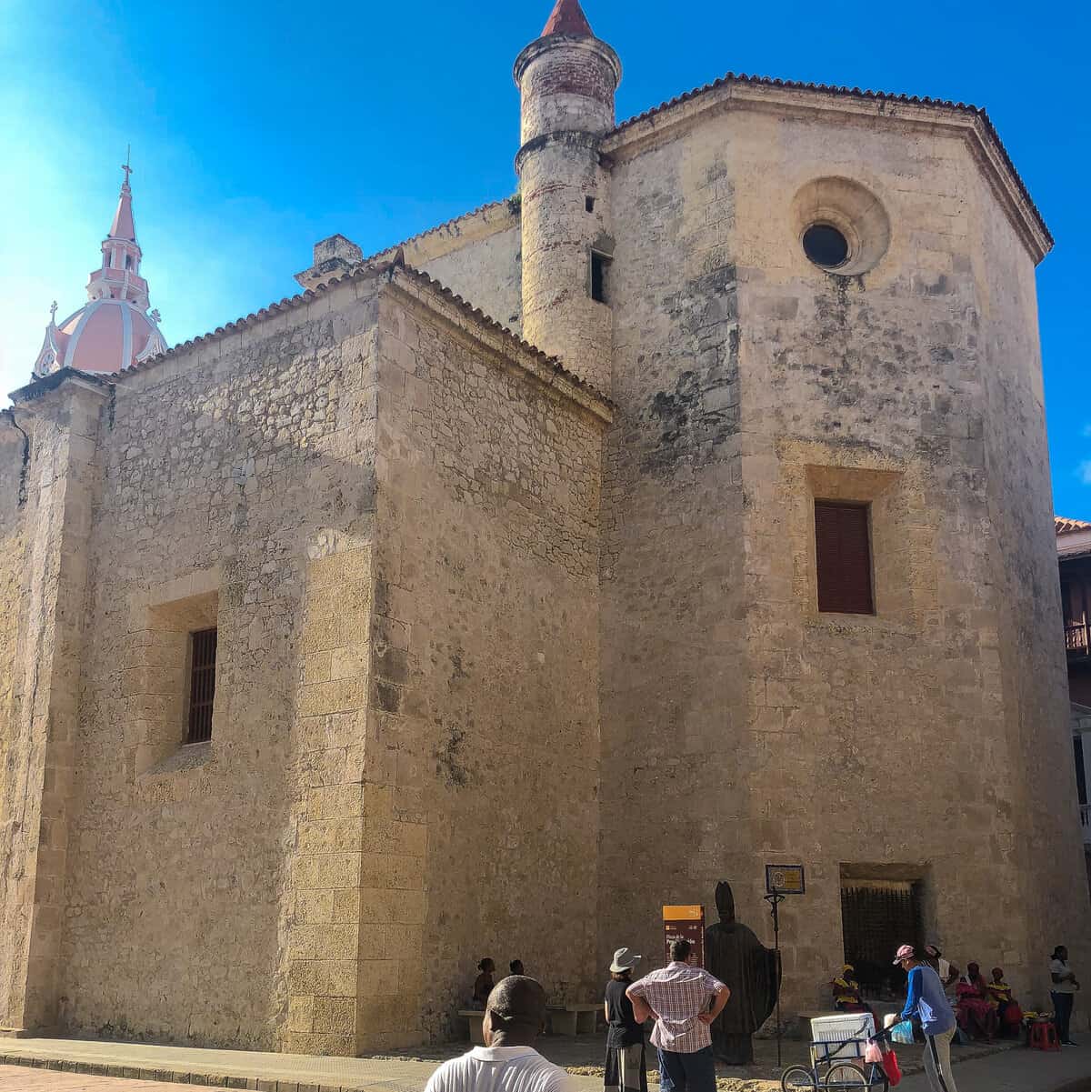 Historic Santo Domingo Church in Cartagena, Colombia, beneath a vivid blue sky.