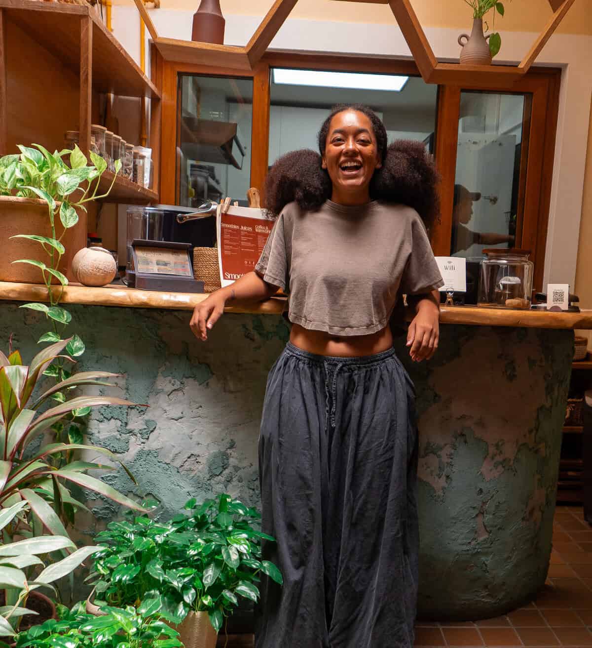 Mia Grenald Sharfi, owner-operator of Vegan Shack, laughing inside her plant-based restaurant in Casco Viejo, Panama.