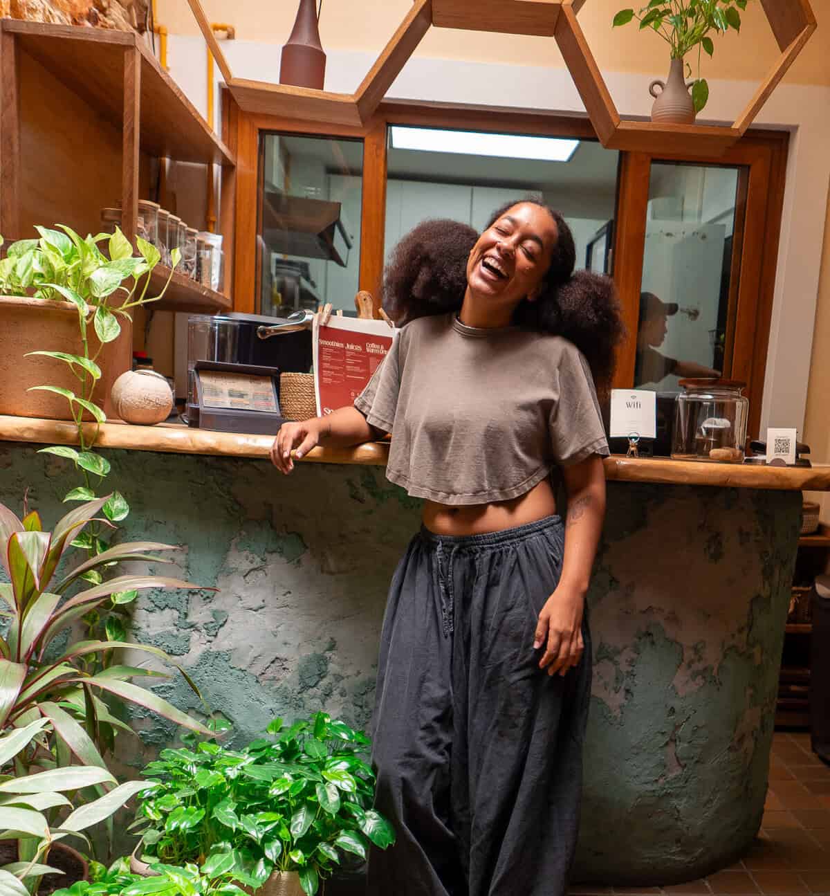 Mia Grenald Sharfi, owner-operator of Vegan Shack, laughing warmly inside her plant-based restaurant in Casco Viejo, Panama.