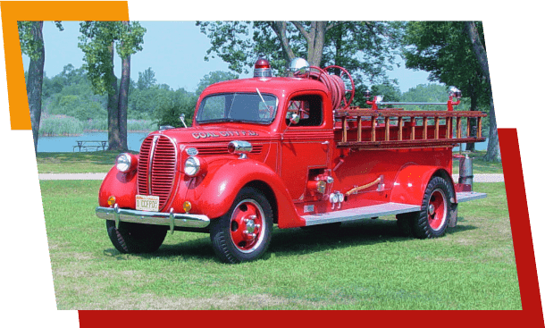 Vintage red fire truck parked on grass