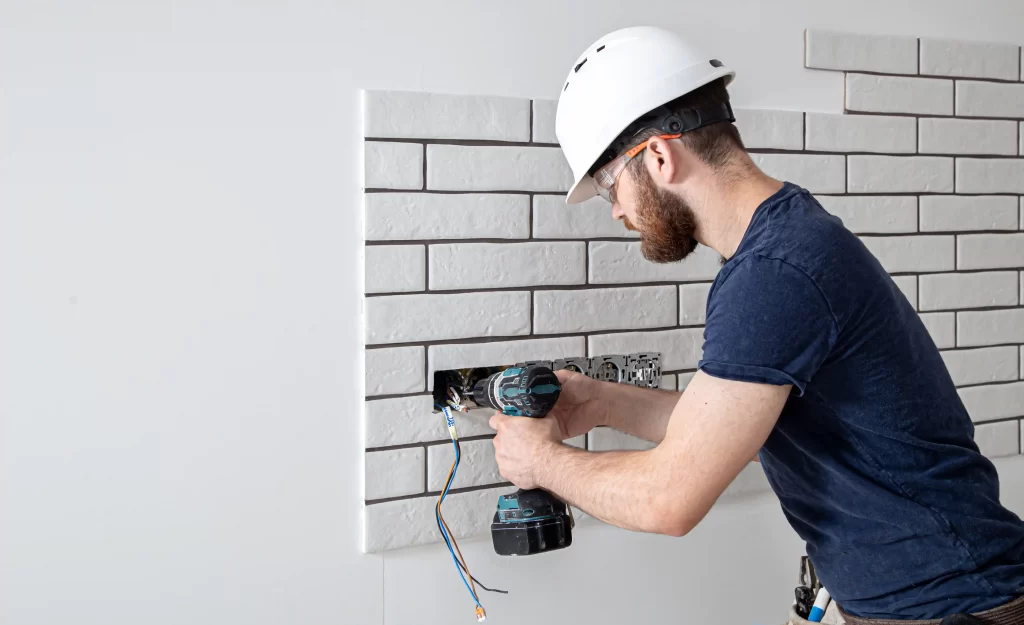A man Installing CCTV - cctv repair dubai
