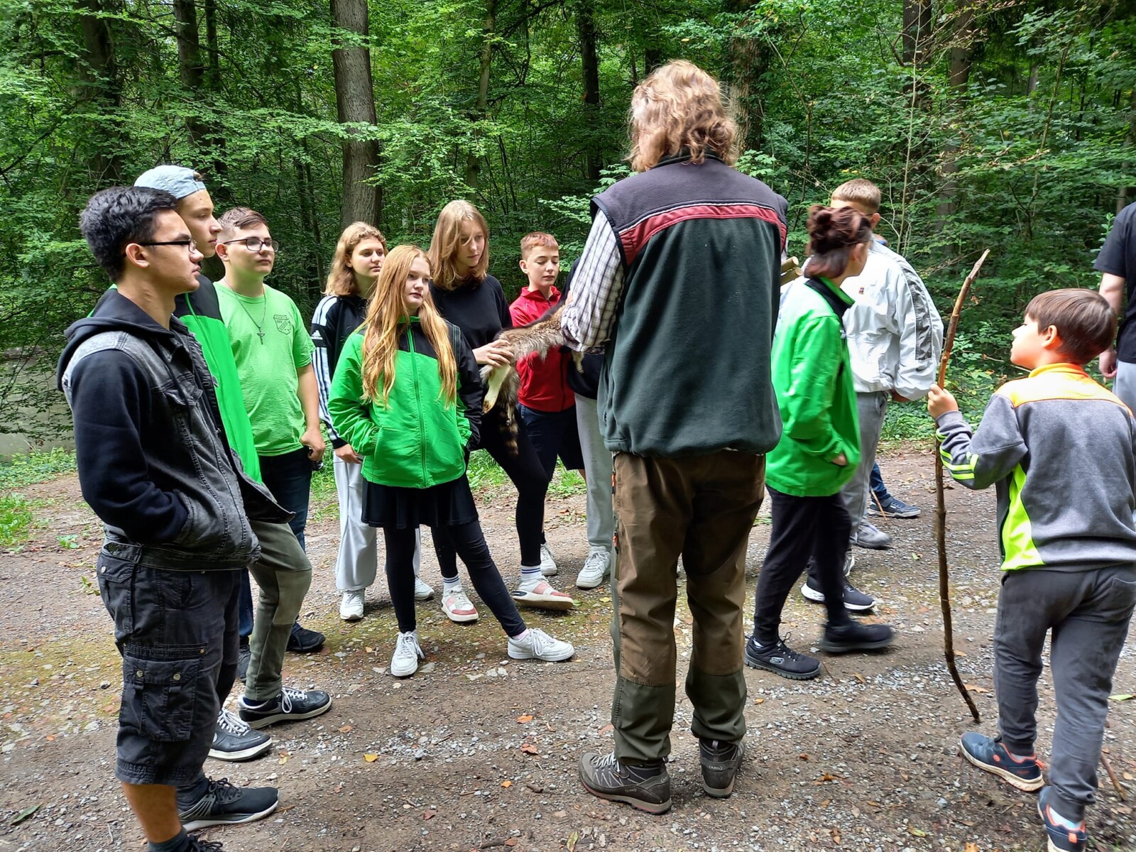 Gruppe beim Bogenschießen im Wald.