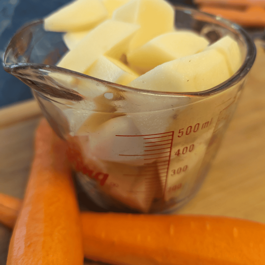cut up potato in measuring cup