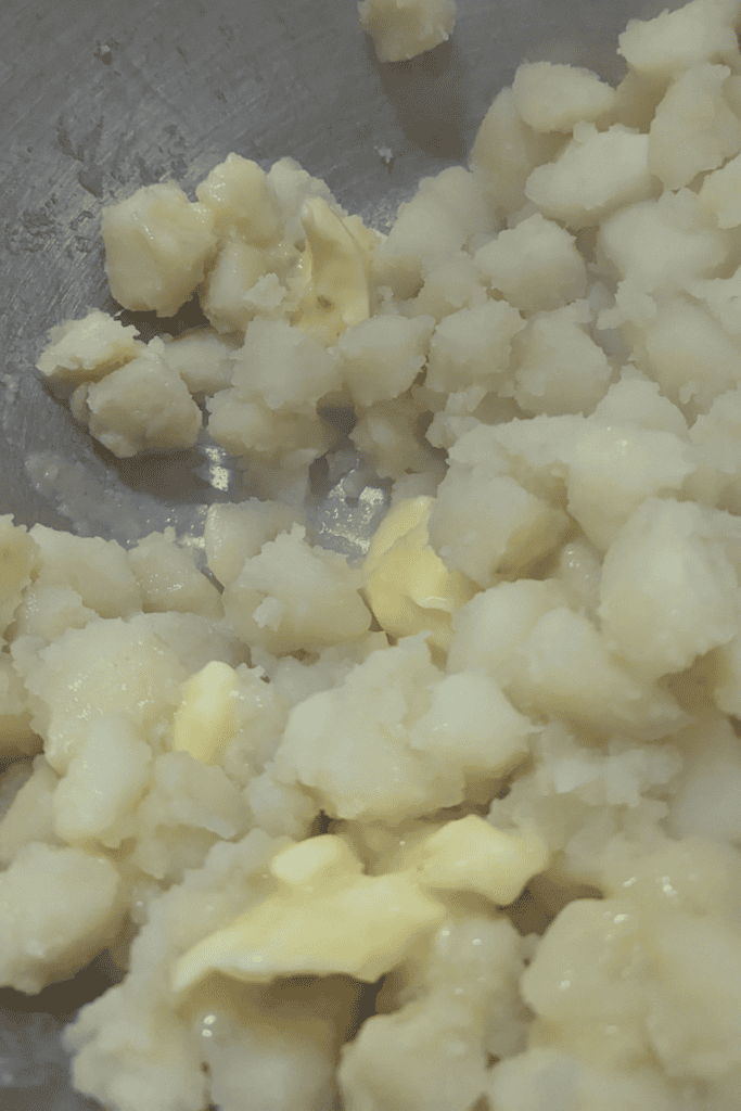 adding butter to parboiled taters