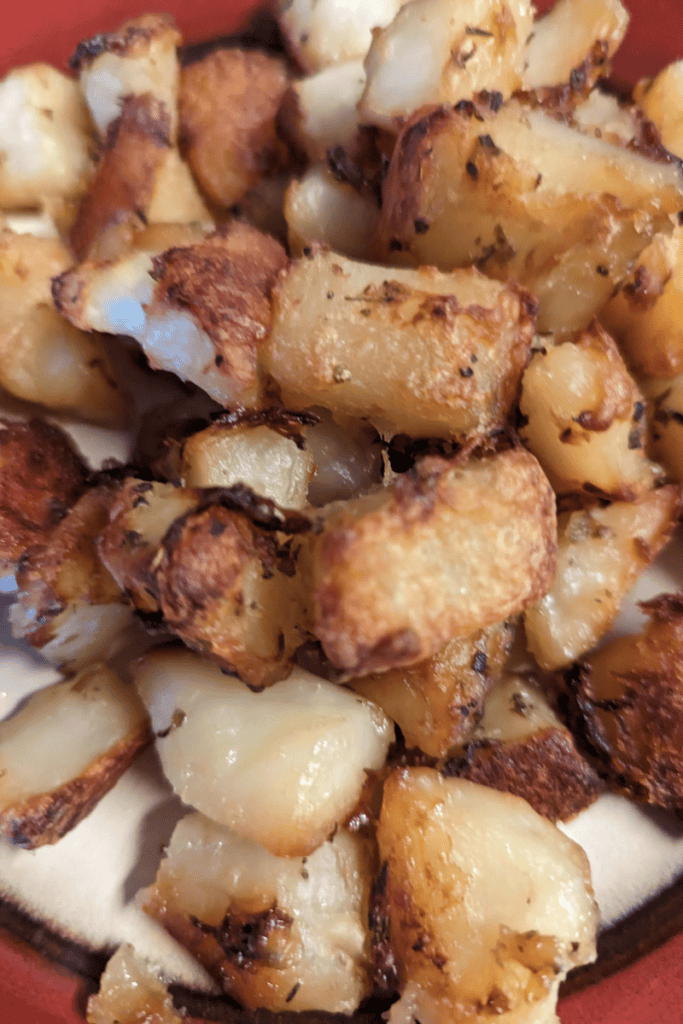 butter herbed crispy golden potatoes on baking sheet