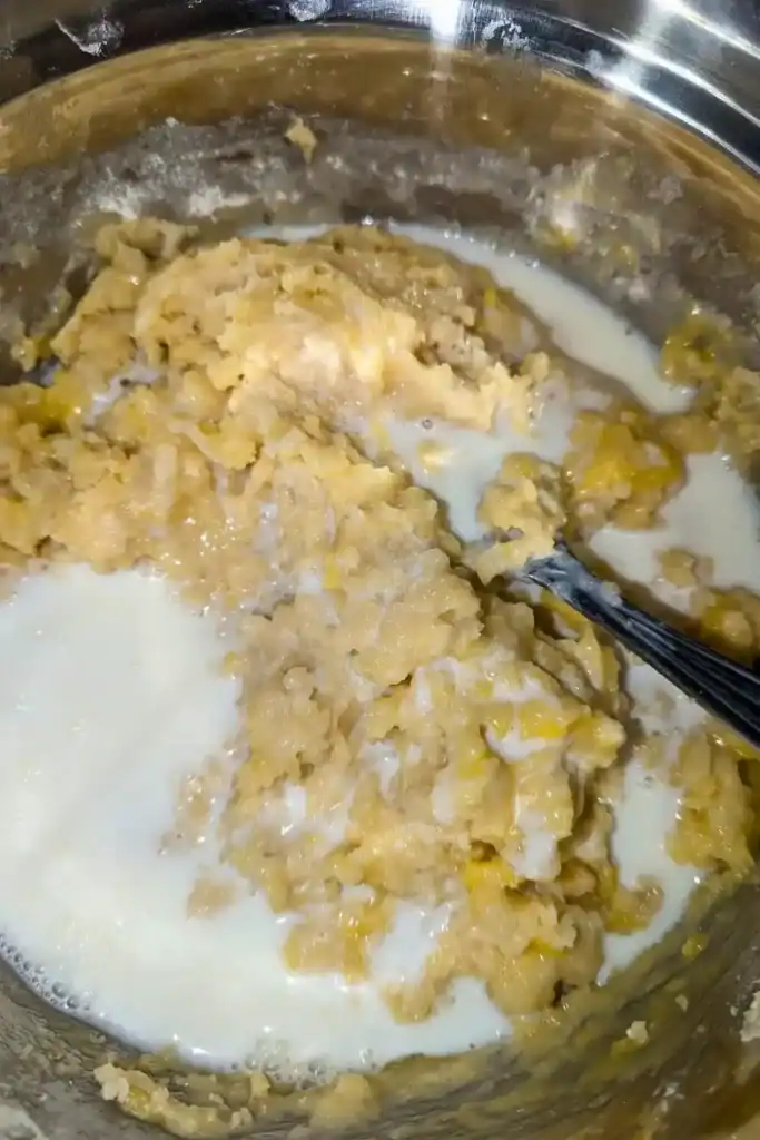 adding the remaining buttermilk into the muffin batter