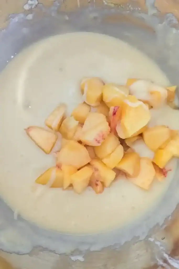 adding the diced peaches to the muffin batter