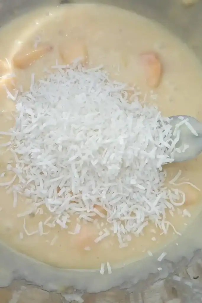 adding shredded coconut to the muffin batter