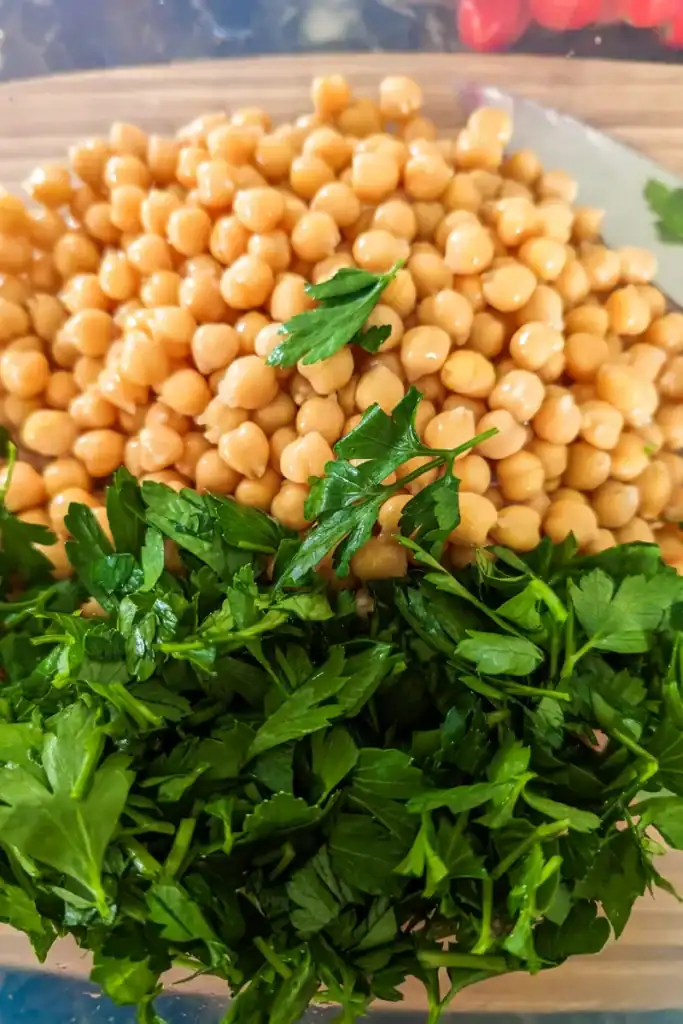 adding Italian parsley to chickpea salad