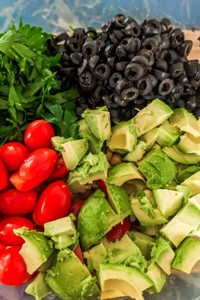 adding chopped avocado and cherry tomatoes