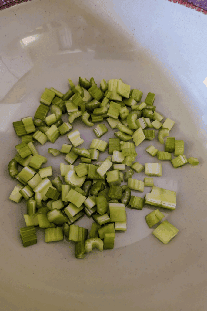 adding diced celery to salad bowl