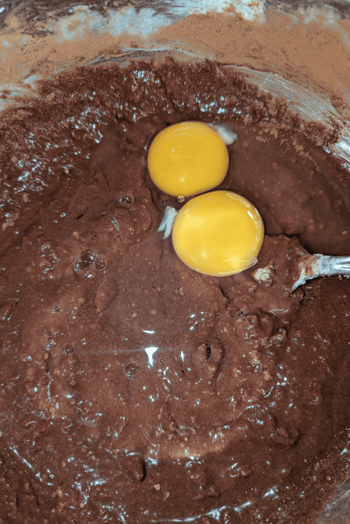 adding eggs to muffin batter