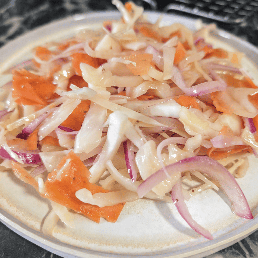 Fresh homemade coleslaw with vinegar-based dressing, no mayo, perfect for healthy salads.
