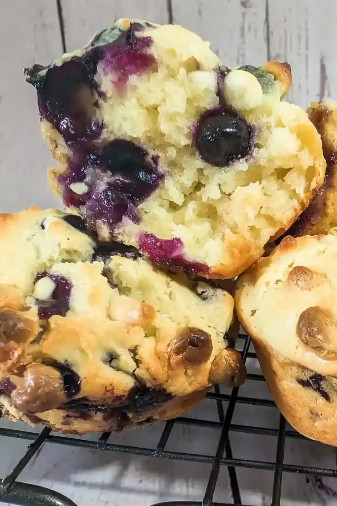 inside a muffin exposing blueberries and soft interior