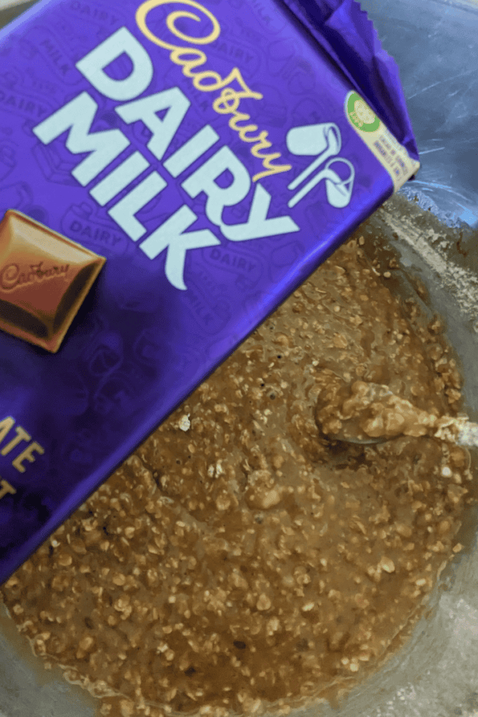 adding Dairy Milk chocolate to coffee banana oatmeal muffin batter