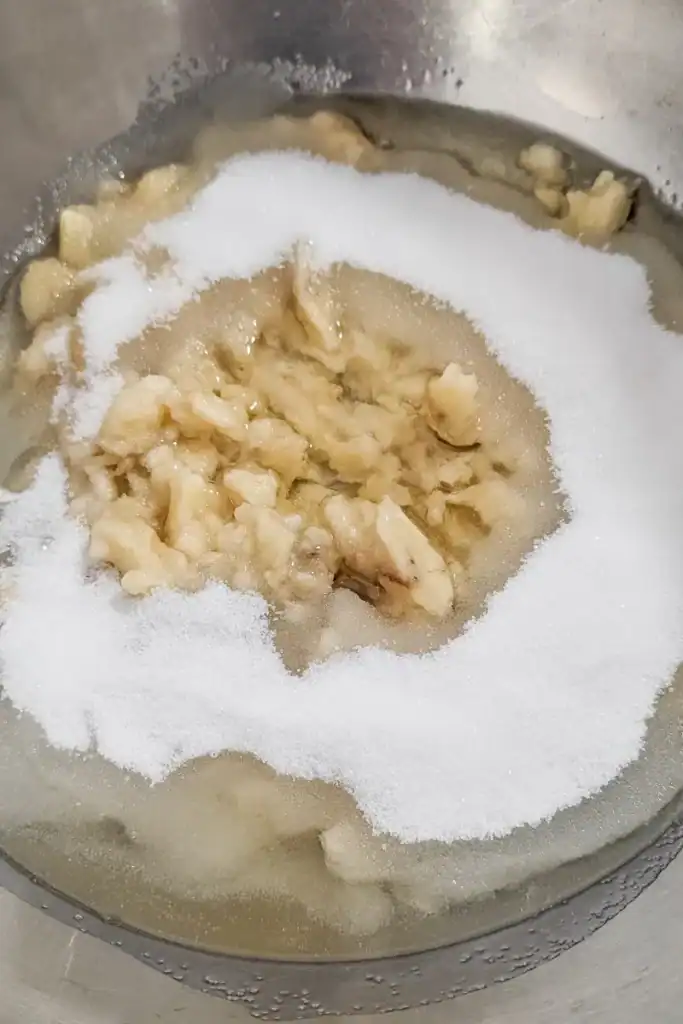 adding sugar and oil to banana