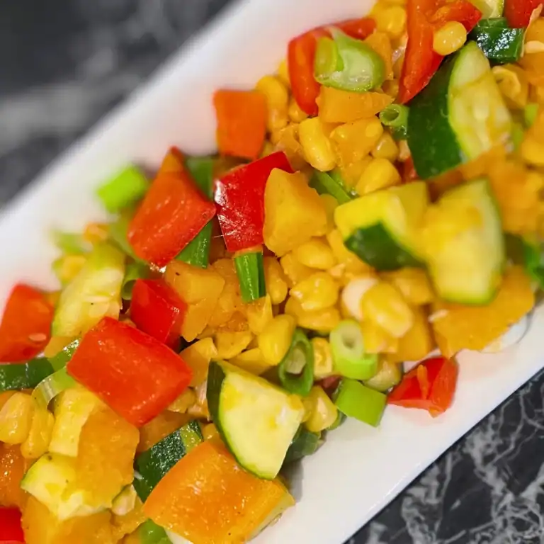 Succotash with Zucchini and Butternut Squash side view white plate on angle kiddy corner to corner