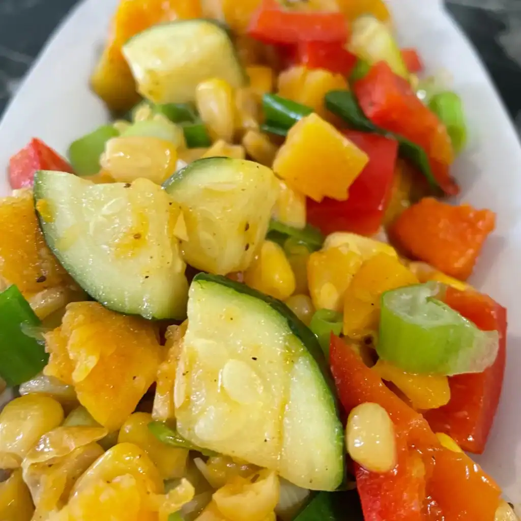 Succotash with Zucchini and Butternut Squash side view white plate