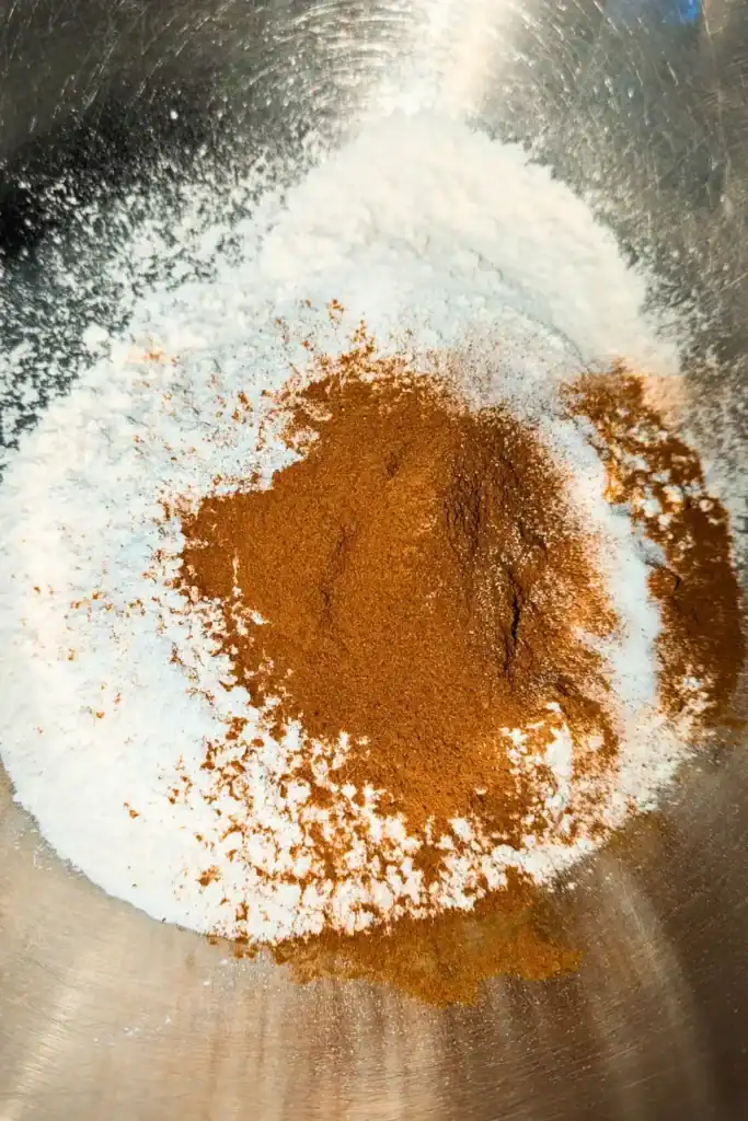 cinnamon and dry ingredients in stainless steel mixing bowl