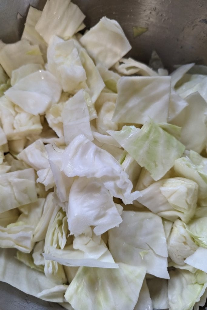 break raw cabbage pieces apart