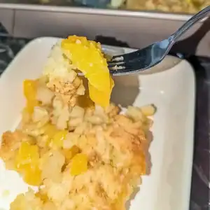 recipe care image of peach cobber peach slice on fork tine