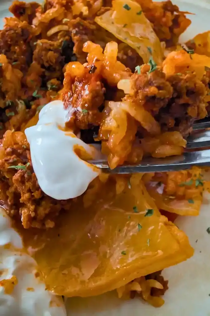 lazy cabbage roll casserole with sour cream on fork
