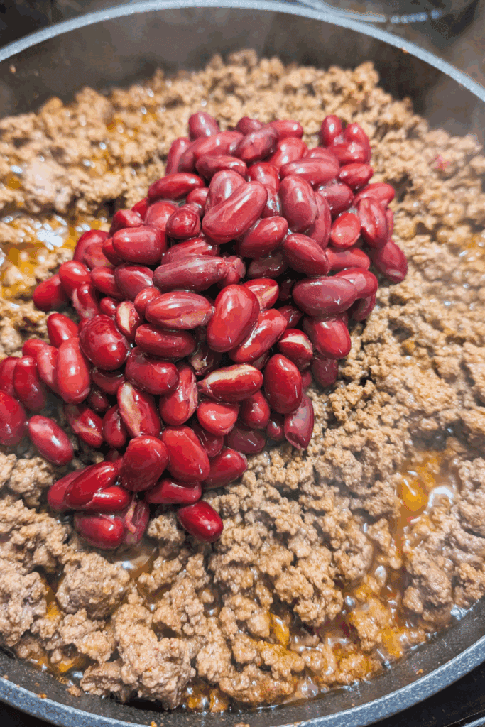 Fresh cooked ground beef with pomegranate seeds in a skillet for delicious recipes.