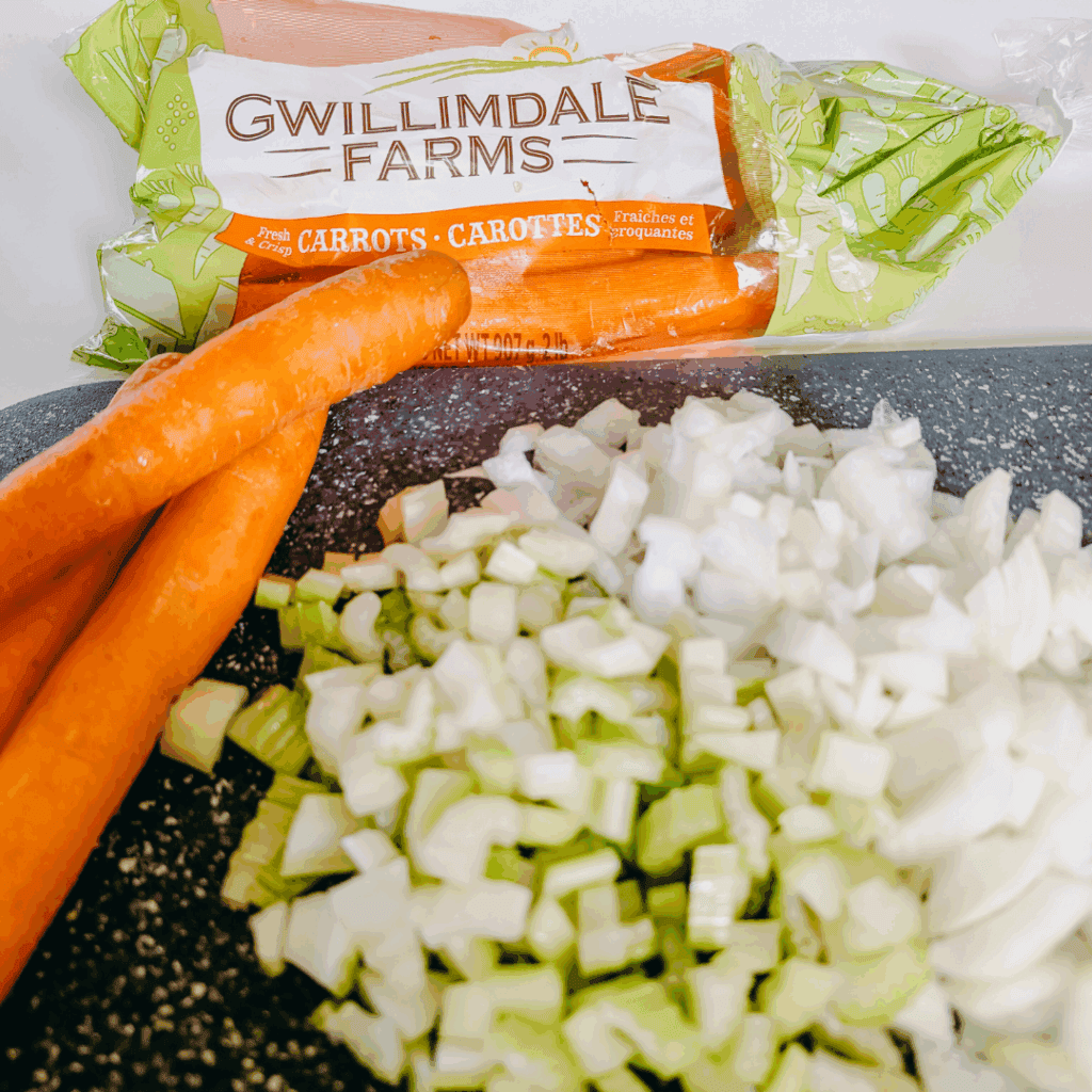 Carrots and chopped onions for cooking or meal prep.
