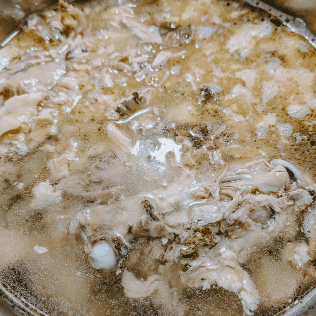 Boiling chicken and broth for homemade cooking and recipes.