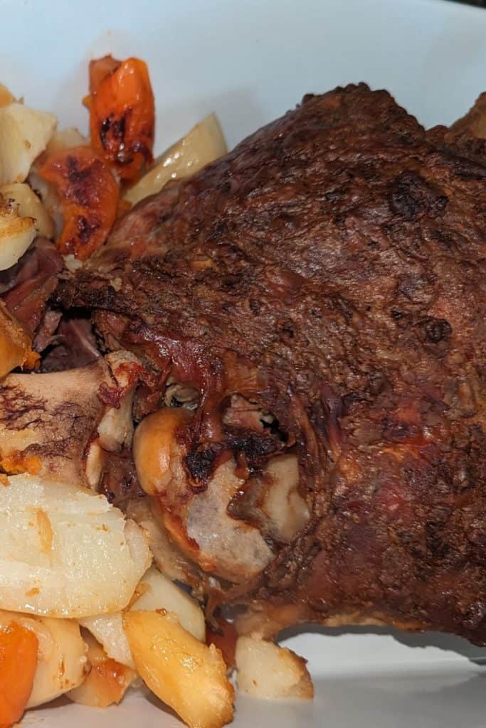 fall off the bone leg of lamb and vegetables