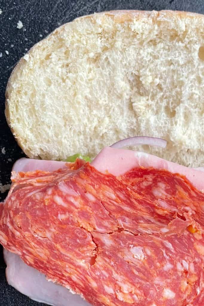 adding calabrese salami to Italian Scotch Baps sandwich