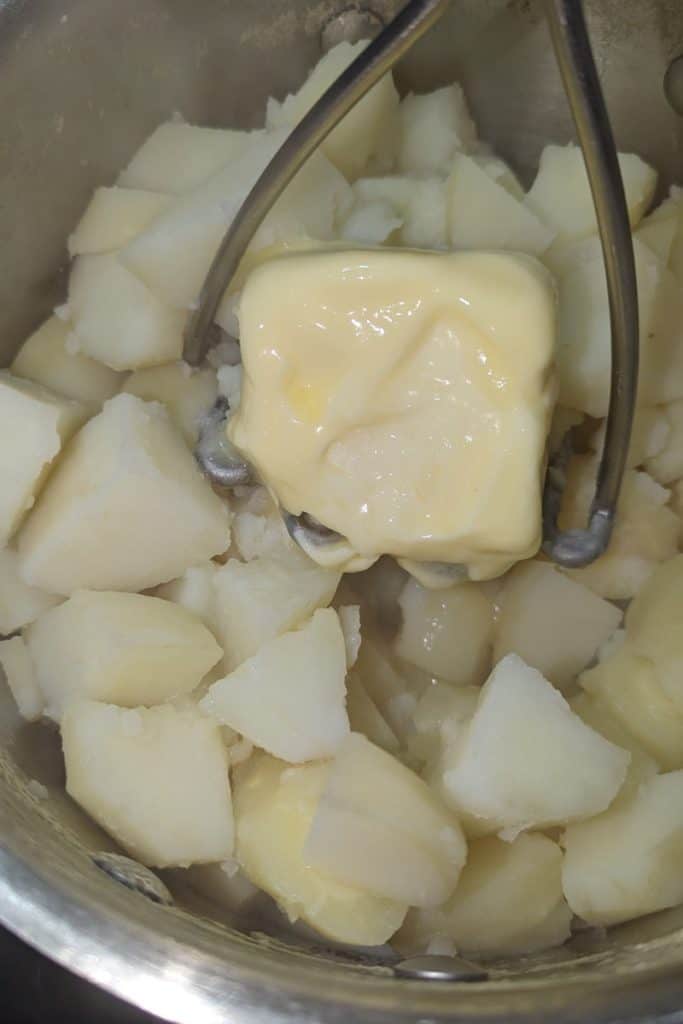 mash butter into vegetables until fully blended