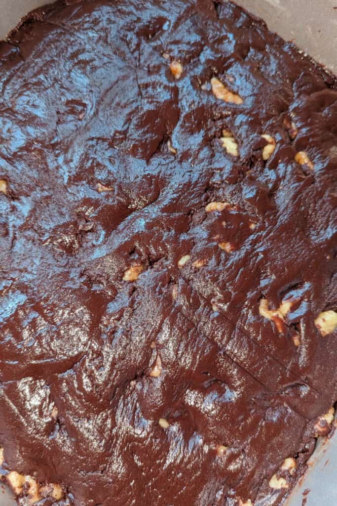 pat semi-sweet chocolate walnut fudge mixture down evenly in pan