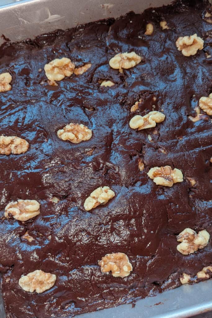 top the semi-sweet chocolate walnut fudge with half walnuts