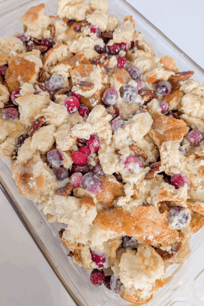 Cranberry and pecan bread pudding with vanilla glaze, perfect for holiday desserts.