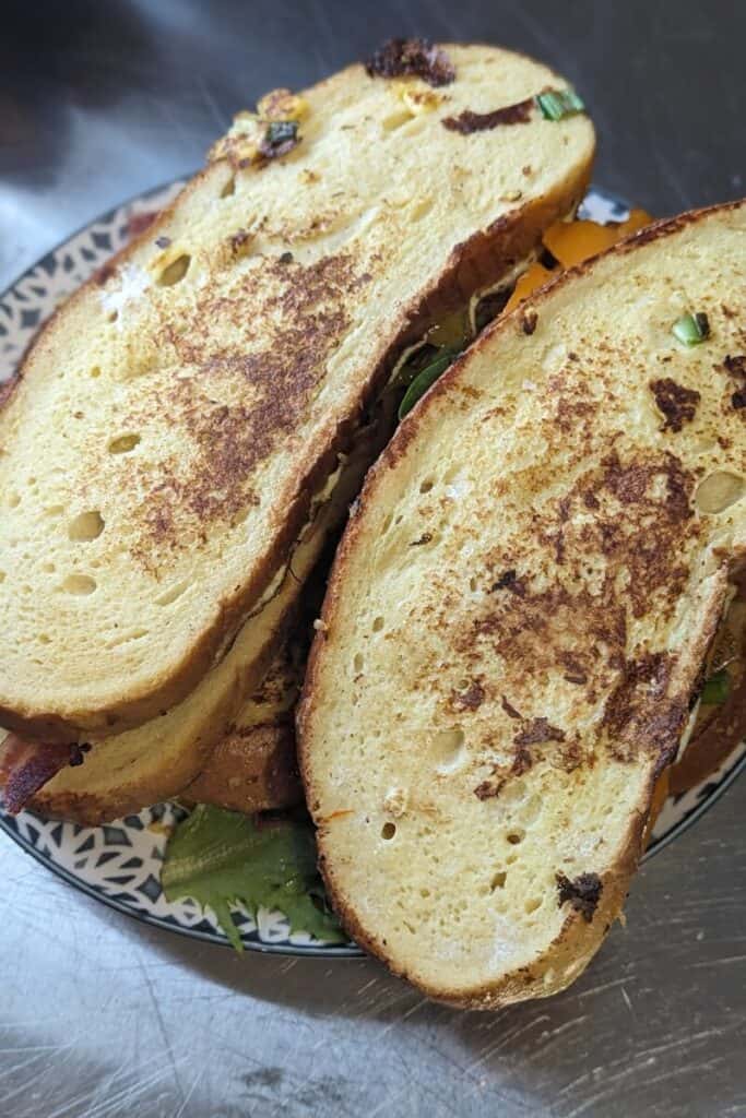 put top slice of sourdough on bread and toast more