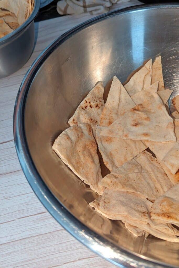 mixing brown butter into the pita triangles