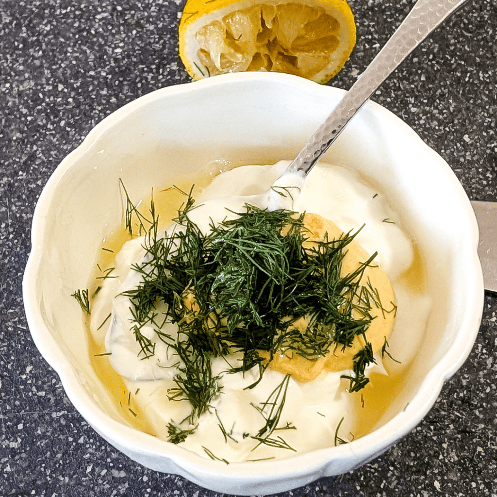 Creamy yogurt dip with lemon and fresh herbs, perfect for snacks or appetizers.
