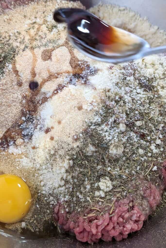 adding soya sauce to hamburger mix