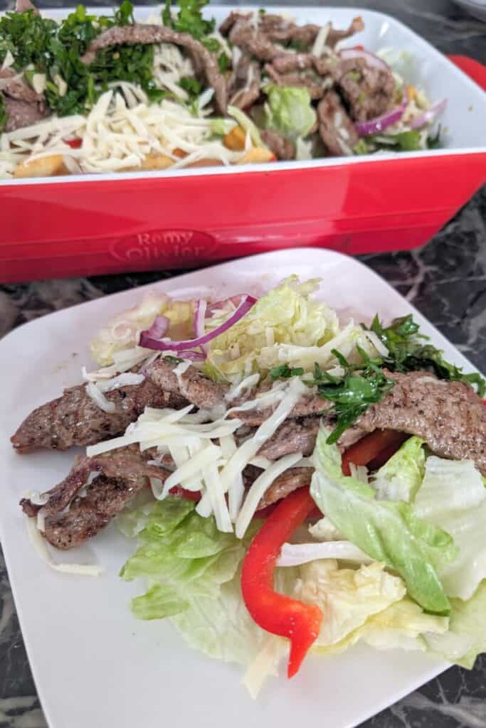 serving steak strip salad with munster cheese