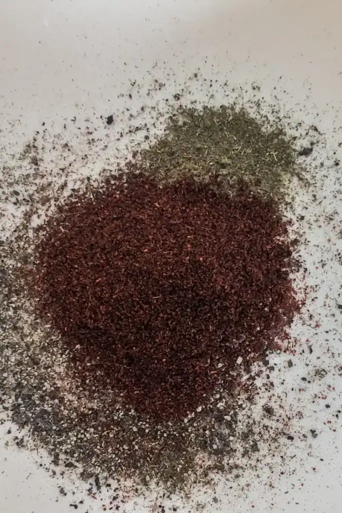 adding achiote pepper to spice blend