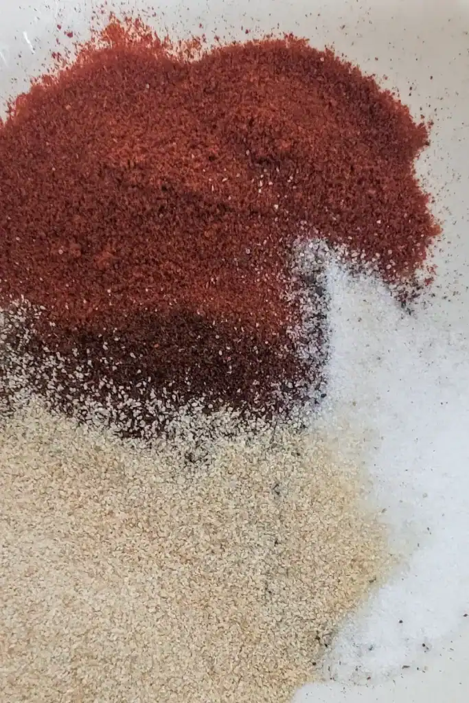 adding garlic powder to spice blend