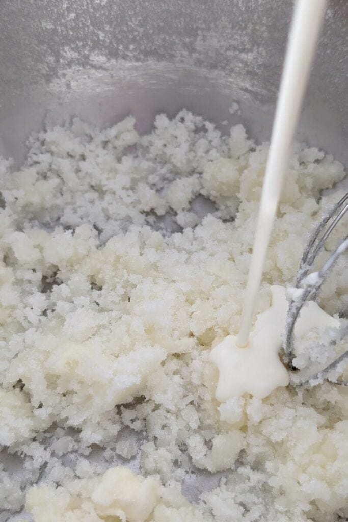 adding heavy cream to sugar cream cheese mix
