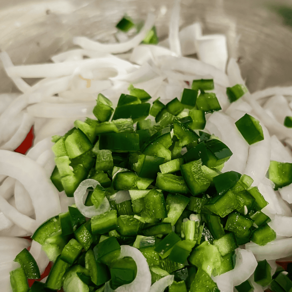 Fresh ingredients for BBQ chicken wraps with onions and green peppers.