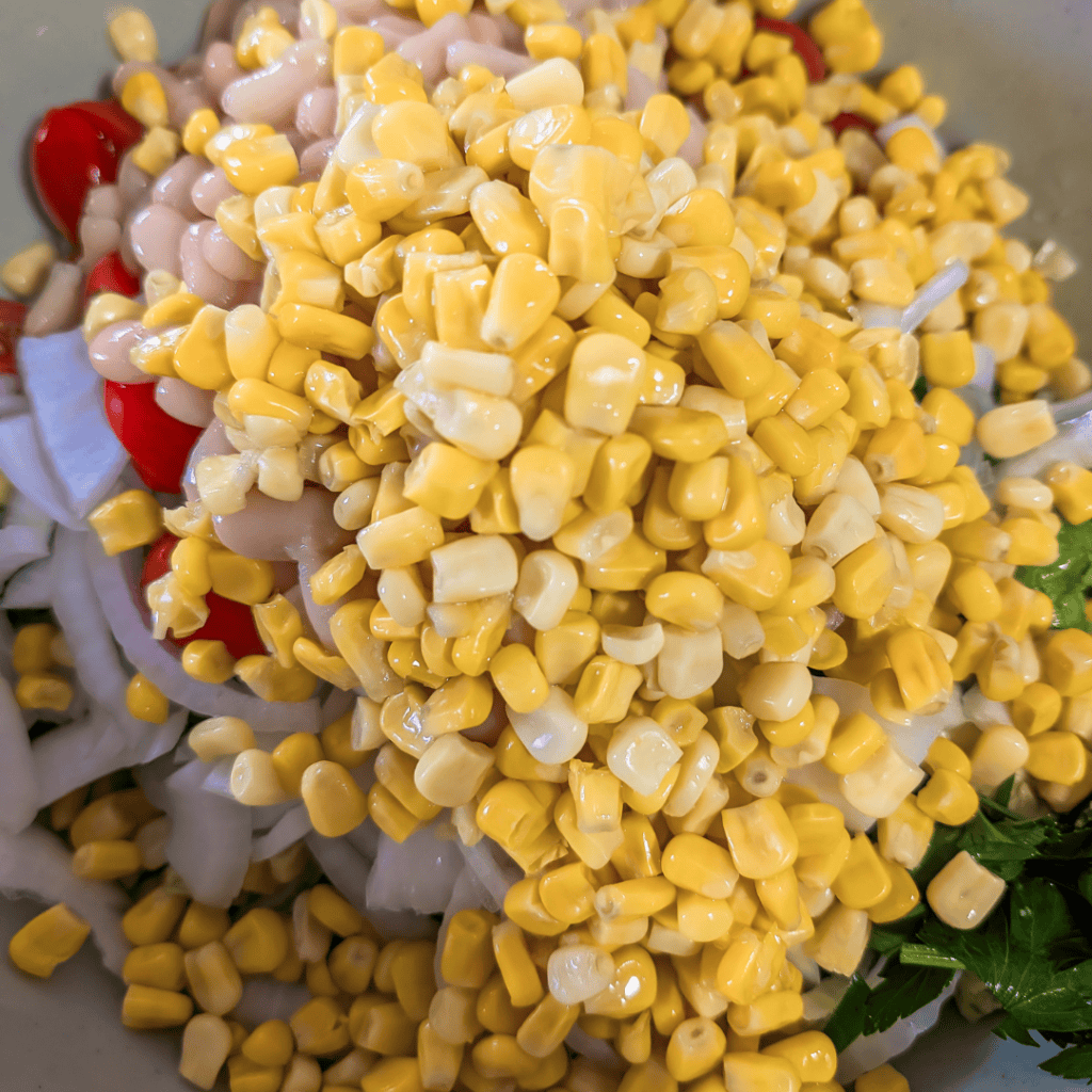 Close-up of BBQ chicken wraps with corn and vegetables.