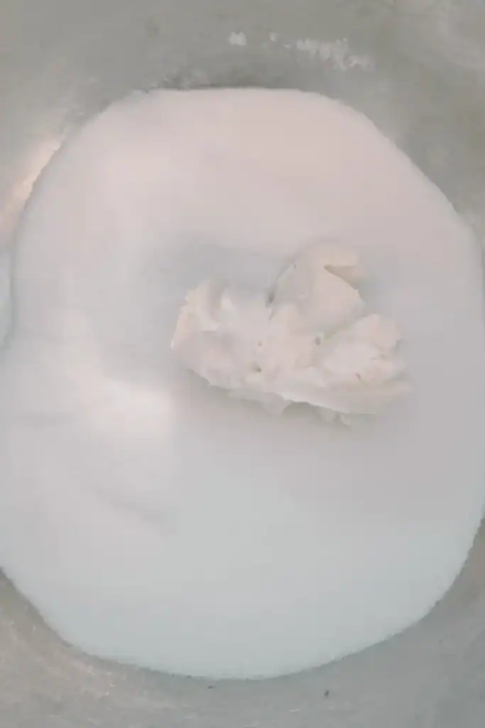 adding white sugar to cream cheese