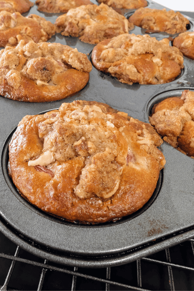 close up corner of muffin tin with rhubarb streusel muffins