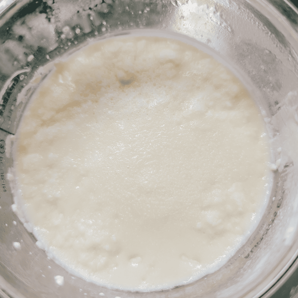 Fresh homemade yogurt in a glass bowl, creamy and smooth.