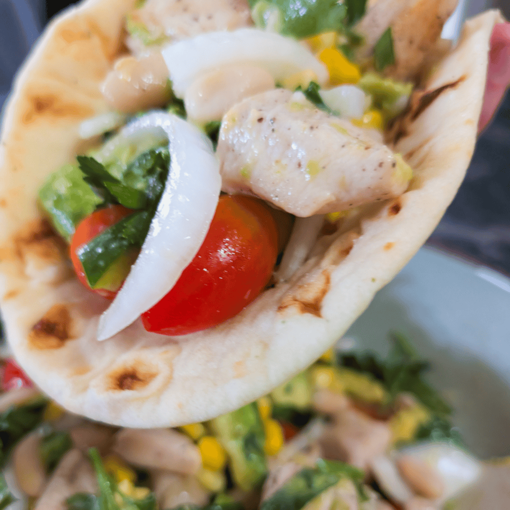 Healthy BBQ Chicken Wrap with fresh vegetables and creamy sauce.