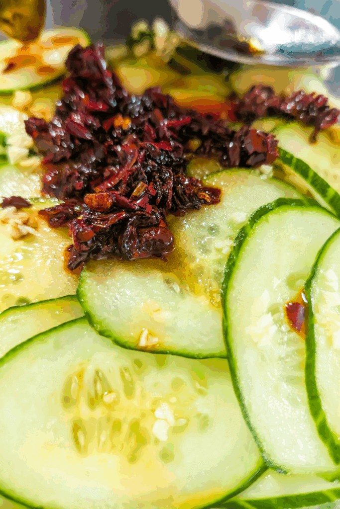 Cucumber slices with fermented chili flakes and garlic for healthy snacking or salads.